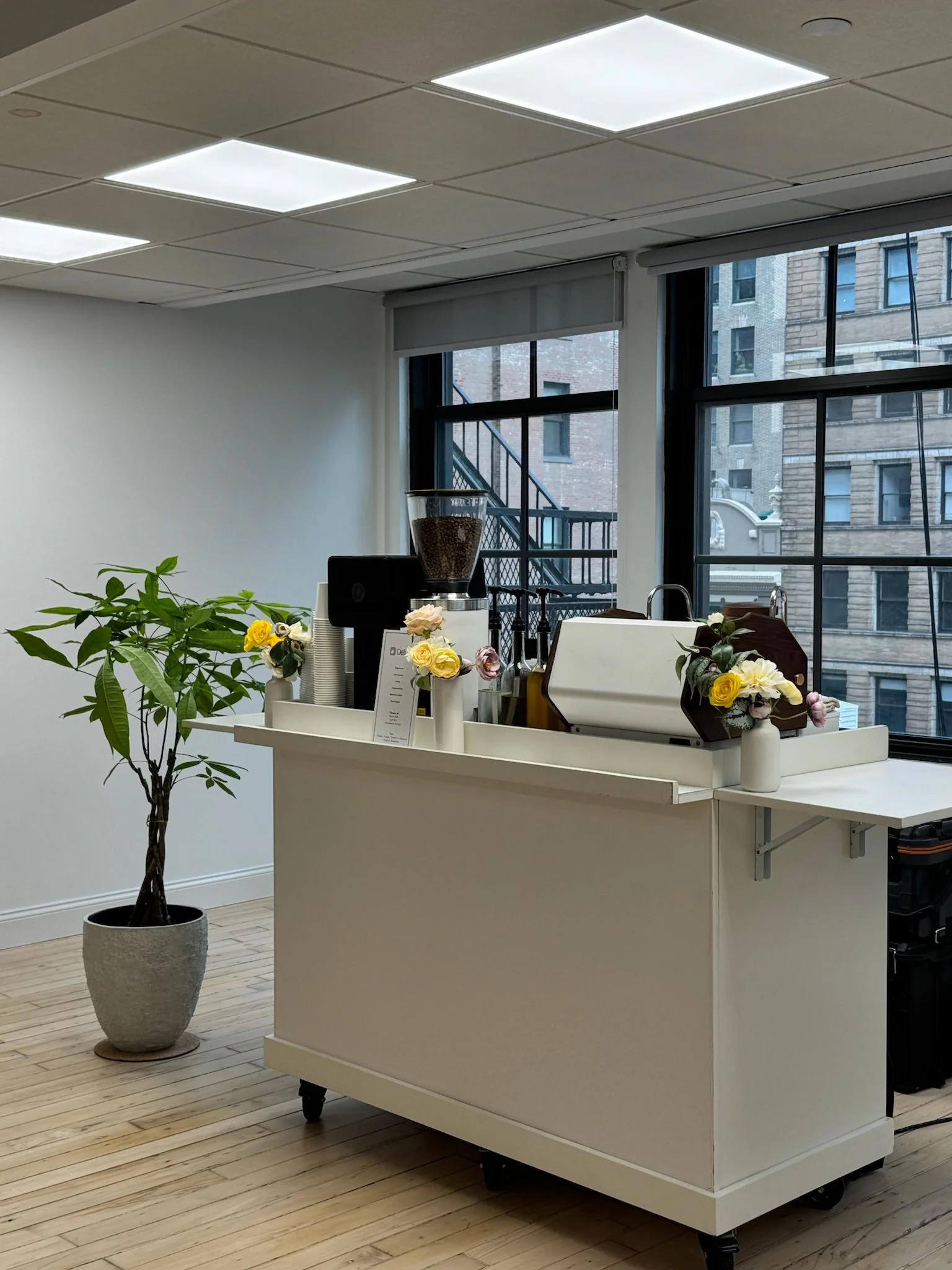 Anechó mobile coffee bar set up beside the windows of a bright Manhattan office for an employee appreciation event