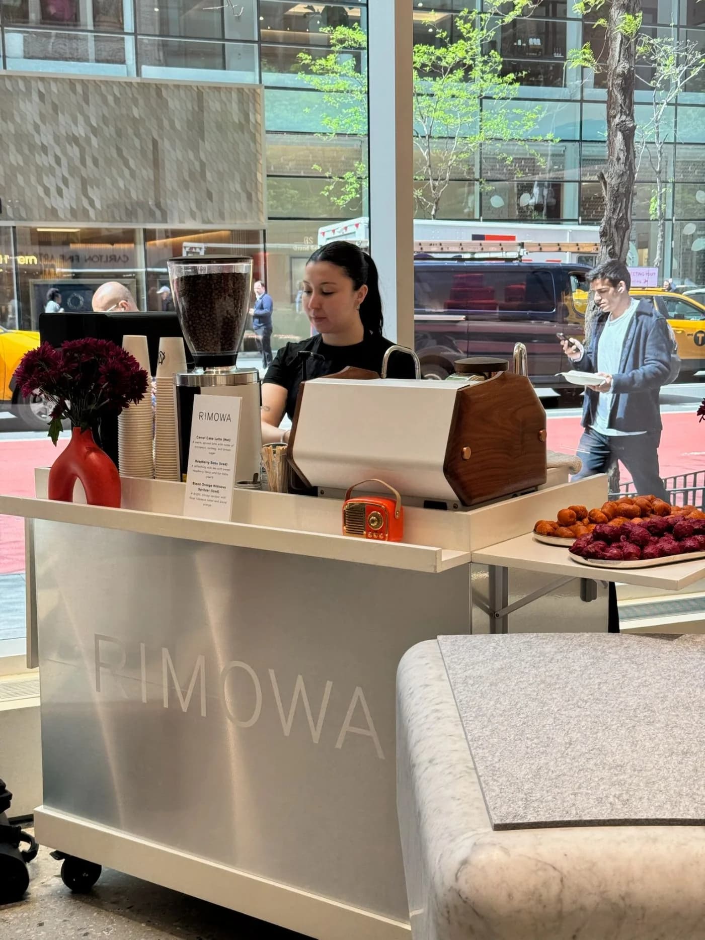 Branded espresso cart styled for a Rimowa retail brand activation