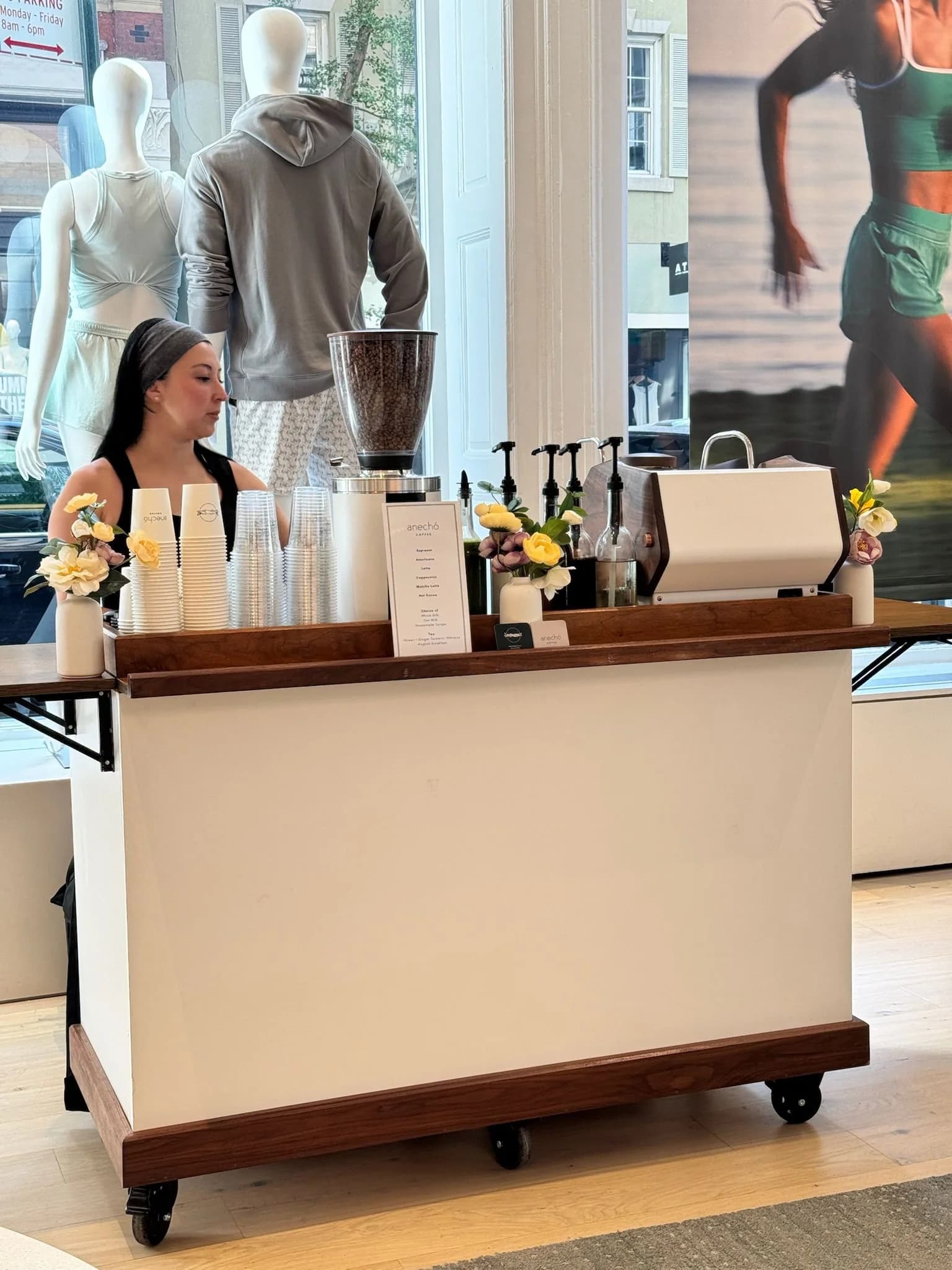 Employees gathered around a mobile coffee bar during an office workplace event